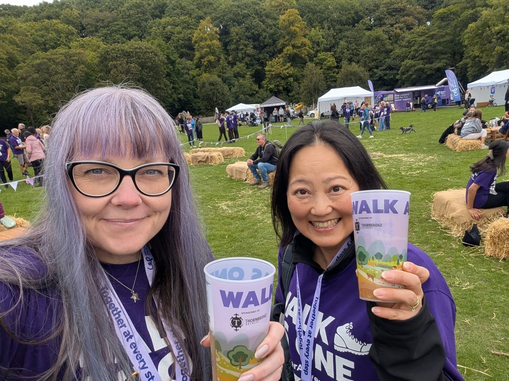 2 colleagues celebrating finishing the race with a drink