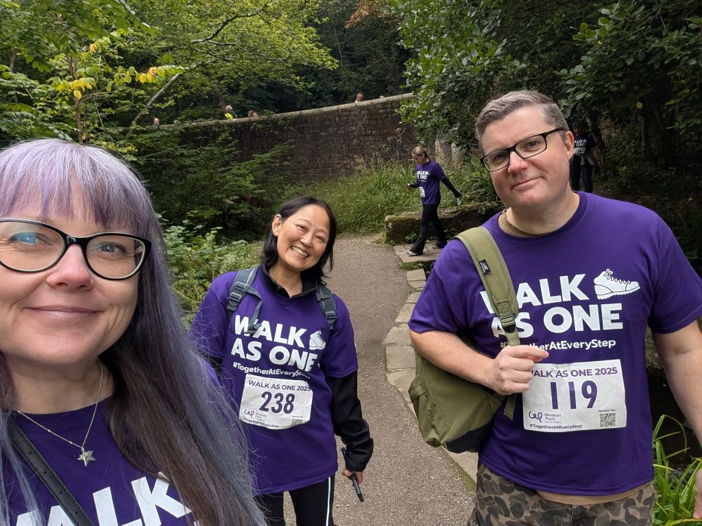 3 colleagues from Weston Park walking through a wood