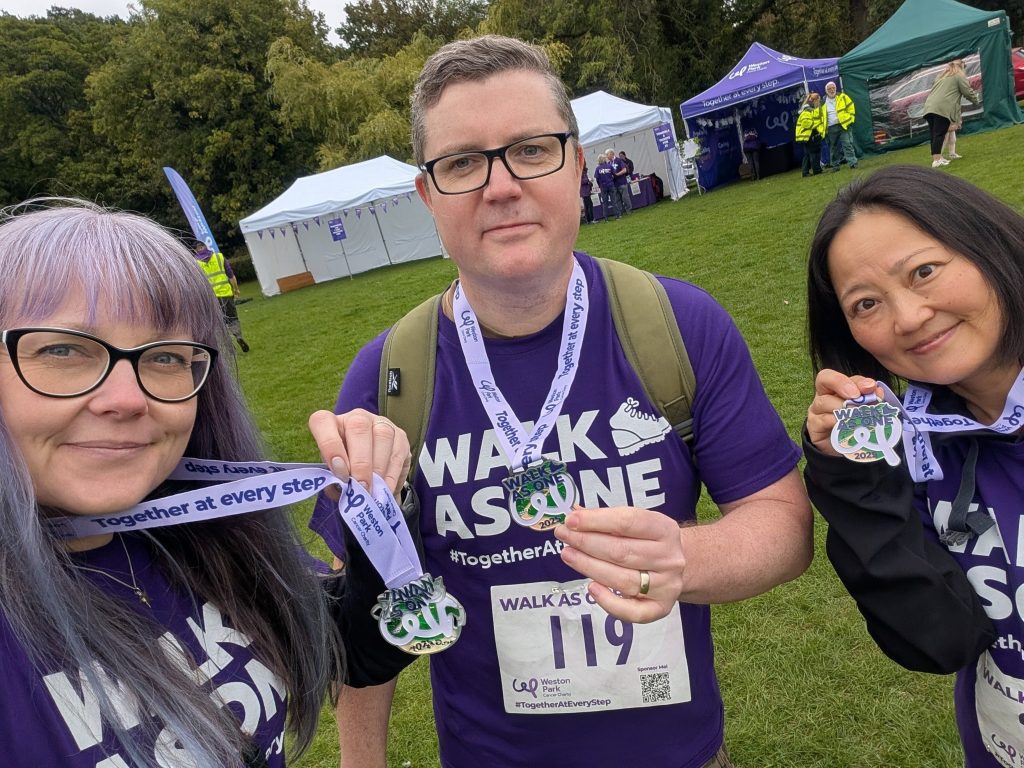 3 colleagues celebrate with medals