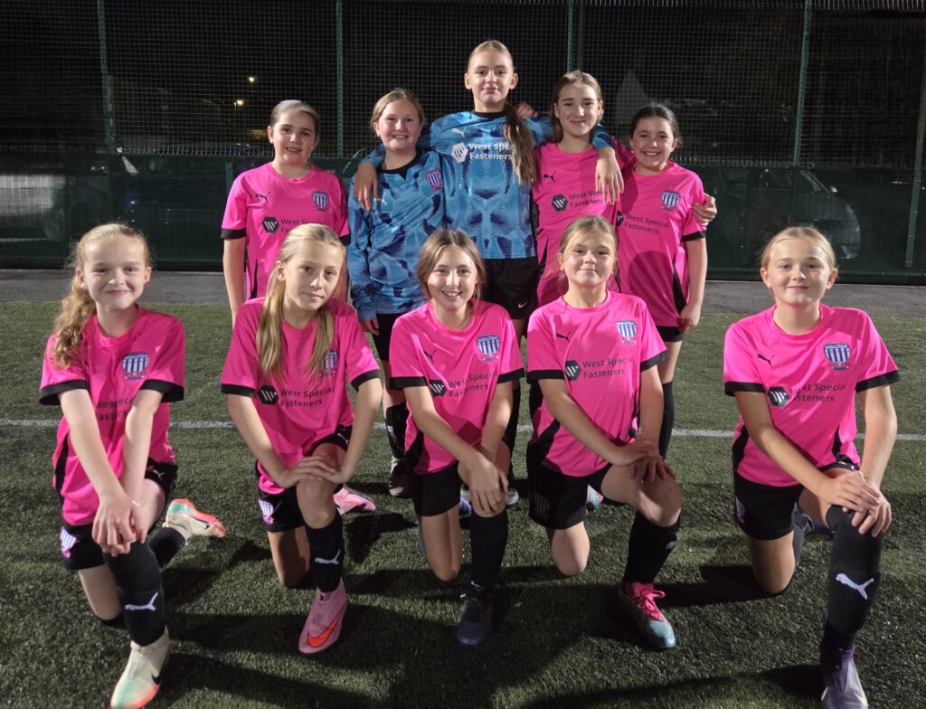 u12 girls gold football team pose in their shirts sponsored by West Special Fasteners