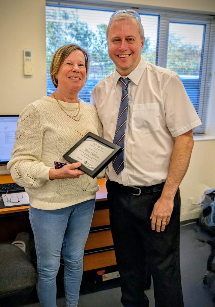 2 colleagues Handing out long service awards