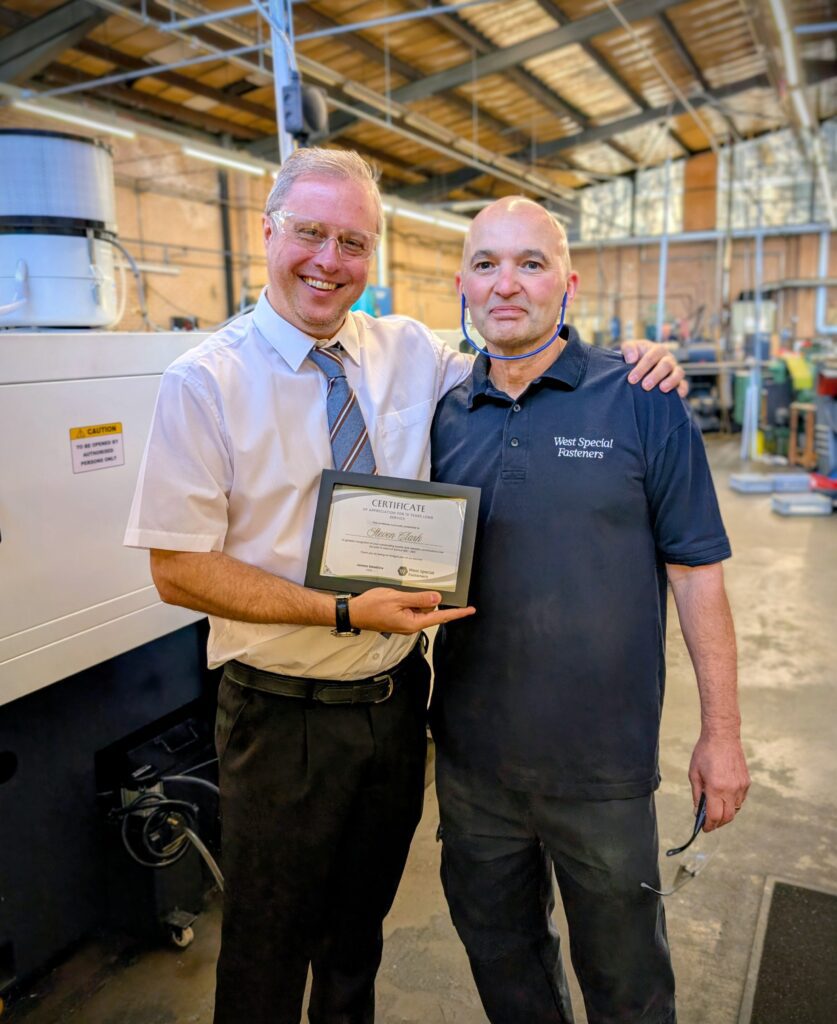 2 colleagues Handing out long service awards