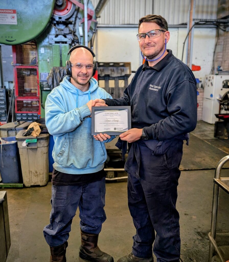 2 colleagues Handing out long service awards