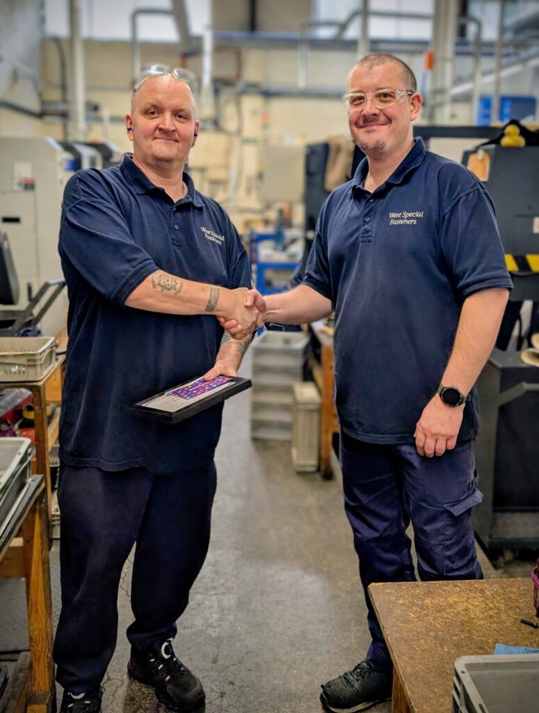 2 colleagues Handing out long service awards